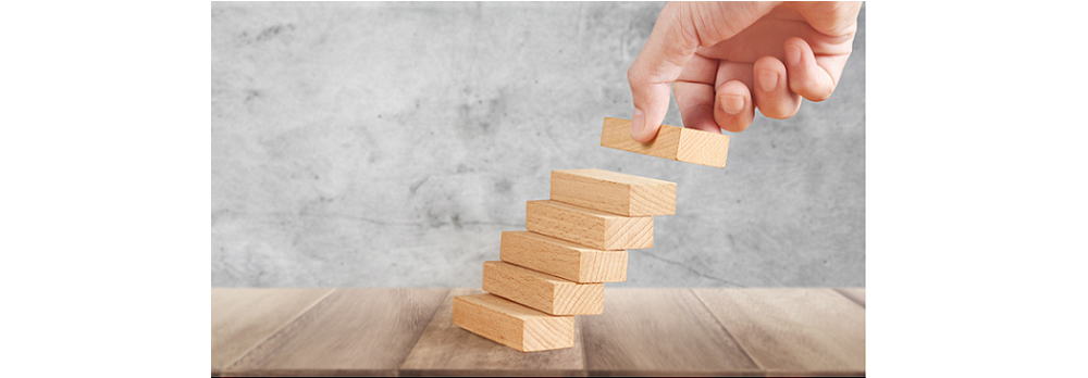 Hand stacking wooden blocks - 5 secrets to building a culture of quality in your service company