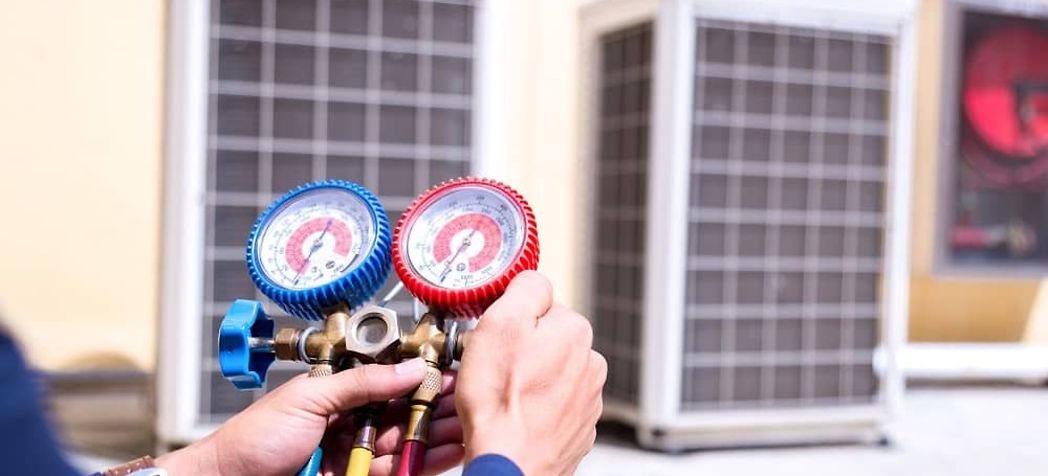 Technician using a pressure gauge - Your complete HVAC technician tool list