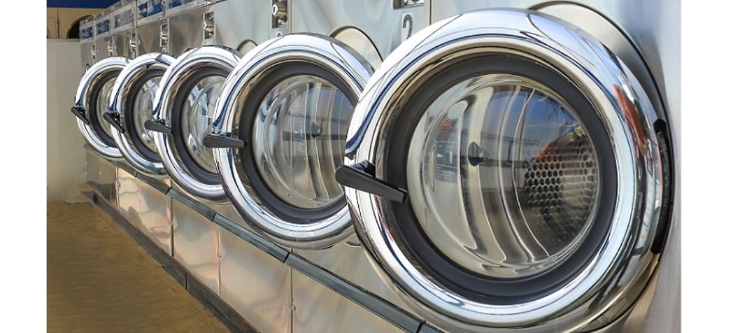 Line of commercial washers in a laundry room - Speed Queen Commercial Washing Machine Troubleshooting