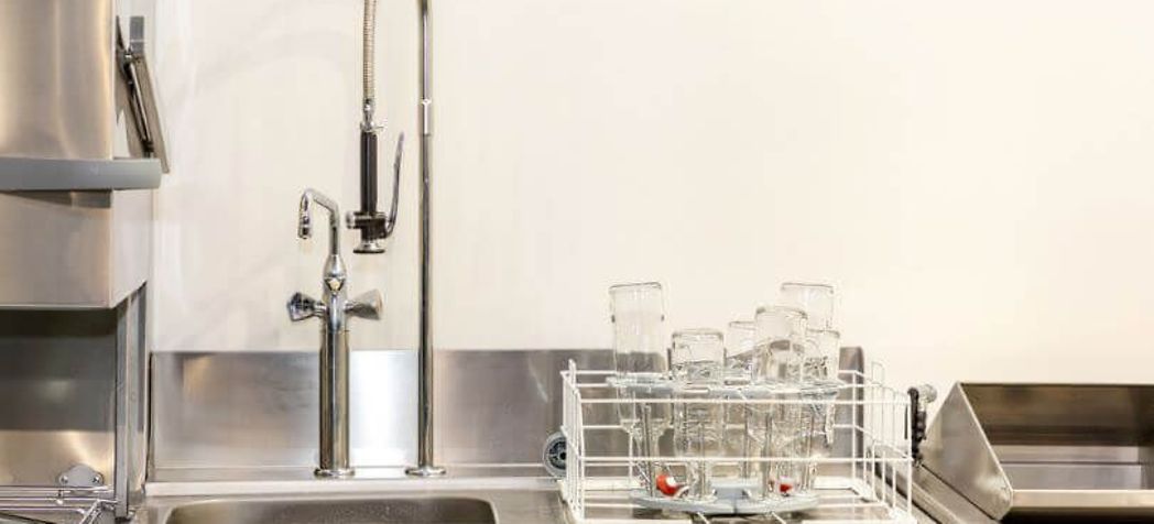 Commercial sink with glasses on the counter - Fisher wall mounted faucet installation