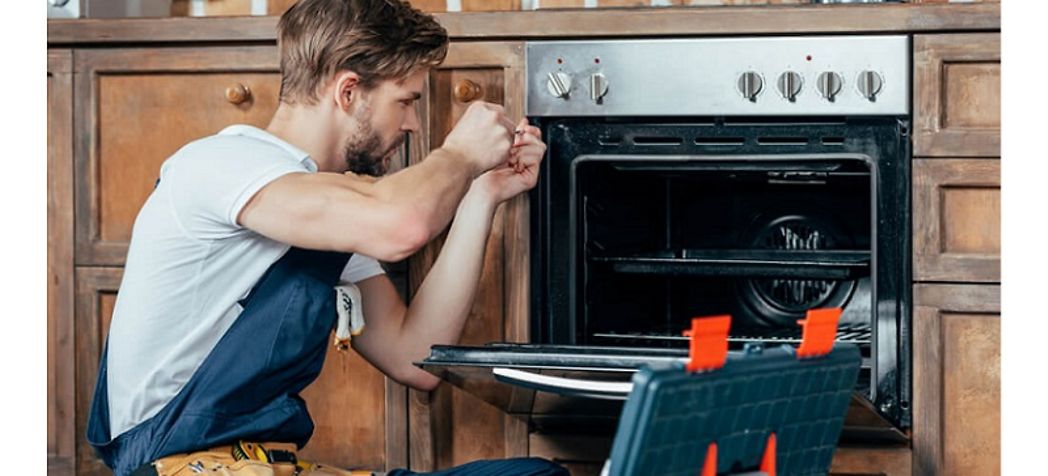 Service technician fixing a commercial oven - Revent oven troubleshooting