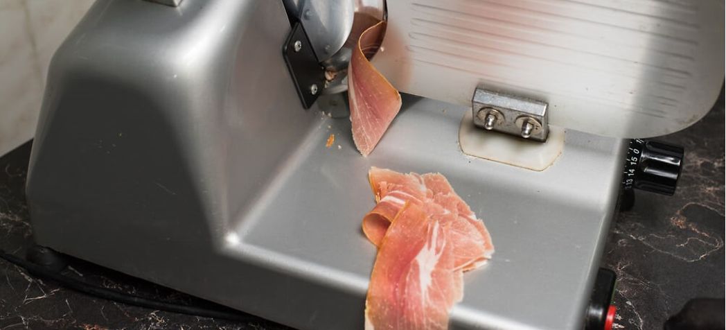 thinly sliced beef going through a meat slicer - How do you remove the blade on a Berkel meat slicer