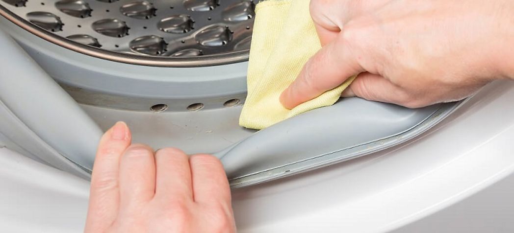 Homeowner cleaning the gasket on his residential washer - Speed Queen washing machine maintenance & cleaning