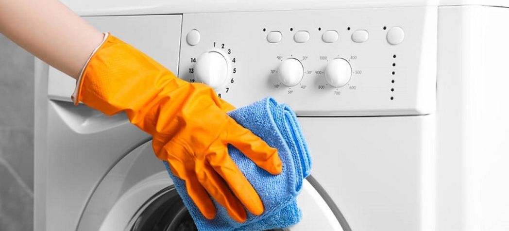Homeowner wiping down their dryer - Electrolux dryer cleaning