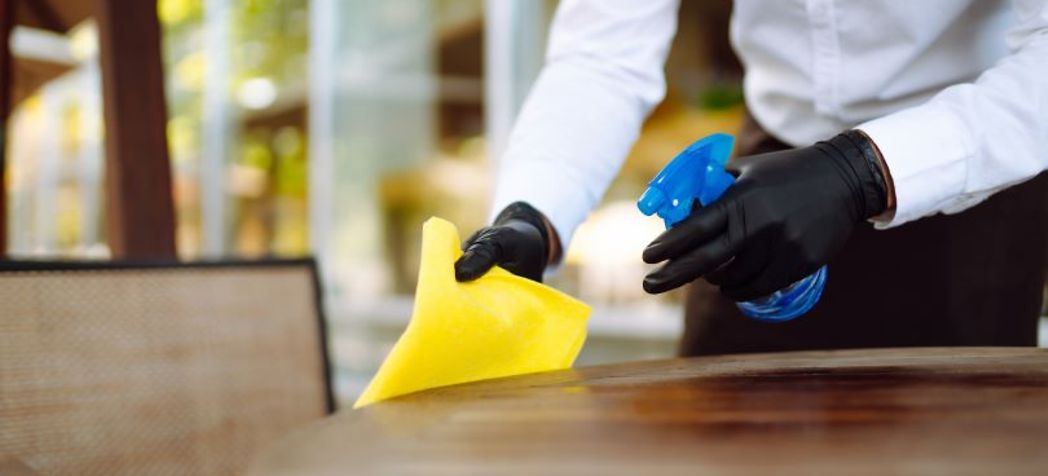 Cleaning a restaurant table - COVID Flu and Cold Safety tips for bars and restaurants