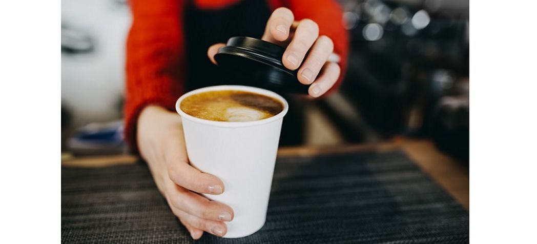 Barista serving a cup of coffee-How to choose a Bunn coffee maker