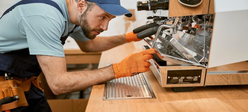 Technician fixing coffee machine - Commercial Foodservice Equipment Repair and the Right to Repair Act