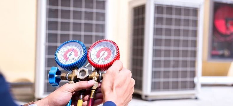 Technician using a pressure gauge - Your complete HVAC technician tool list