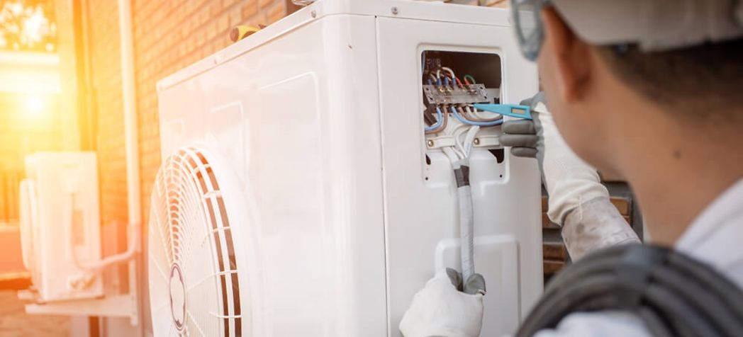 Technician making repairs to a heat pump - Rheem AC & heat pump troubleshooting
