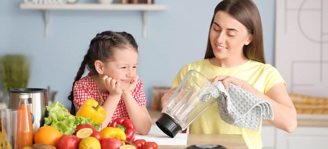 Mother and daughter cleaning a blender - How to clean a residential Blendtec Blender