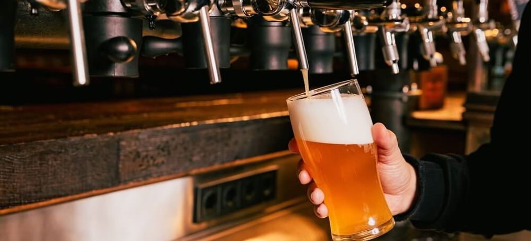 Employee pouring a beer - Lancer Kool Link beer dispenser installation instructions