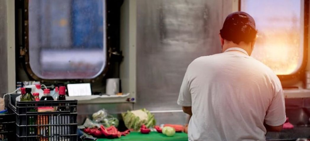 chef in a small kitchen - galley kitchen maintenance checklist