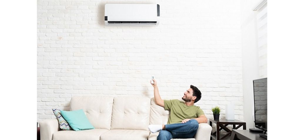 Man turning on his mini split air conditioner - Lennox mini split troubleshooting 