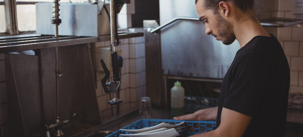 Kitchen Worker Washing Dishes - What is a Pre-Rinse Faucet