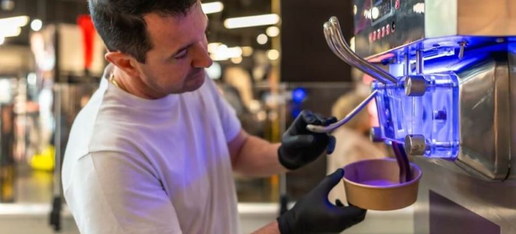 man with black gloves using ice cream machine - Carpigiani gelato machine troubleshooting
