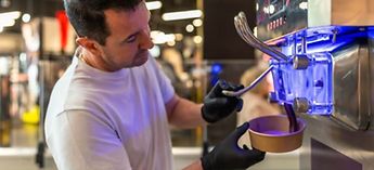 man with black gloves using ice cream machine - Carpigiani gelato machine troubleshooting