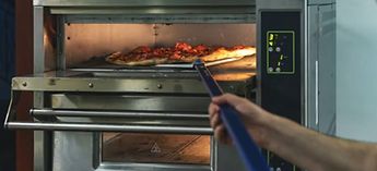 Commercial pizza oven with a pizza going in - Blodgett pizza oven error codes