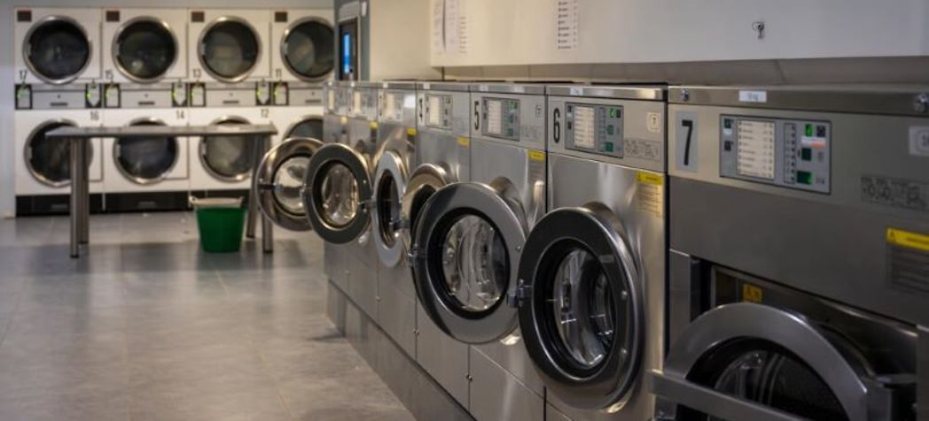 Line of clean commercial washing machines - Alliance Laundry Systems Commercial Washer PM