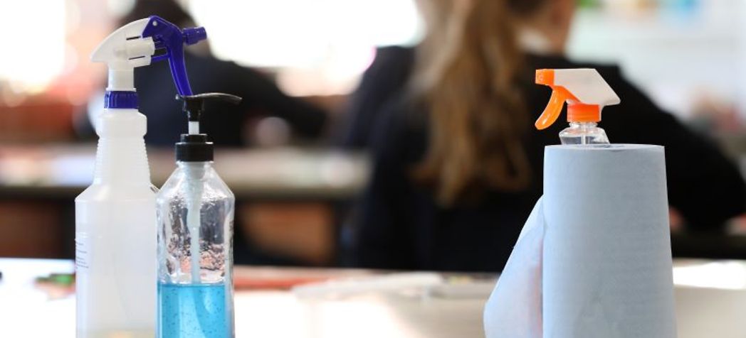 Cleaning a school desk - COVID, Flu & Cold Safety Tips for Schools